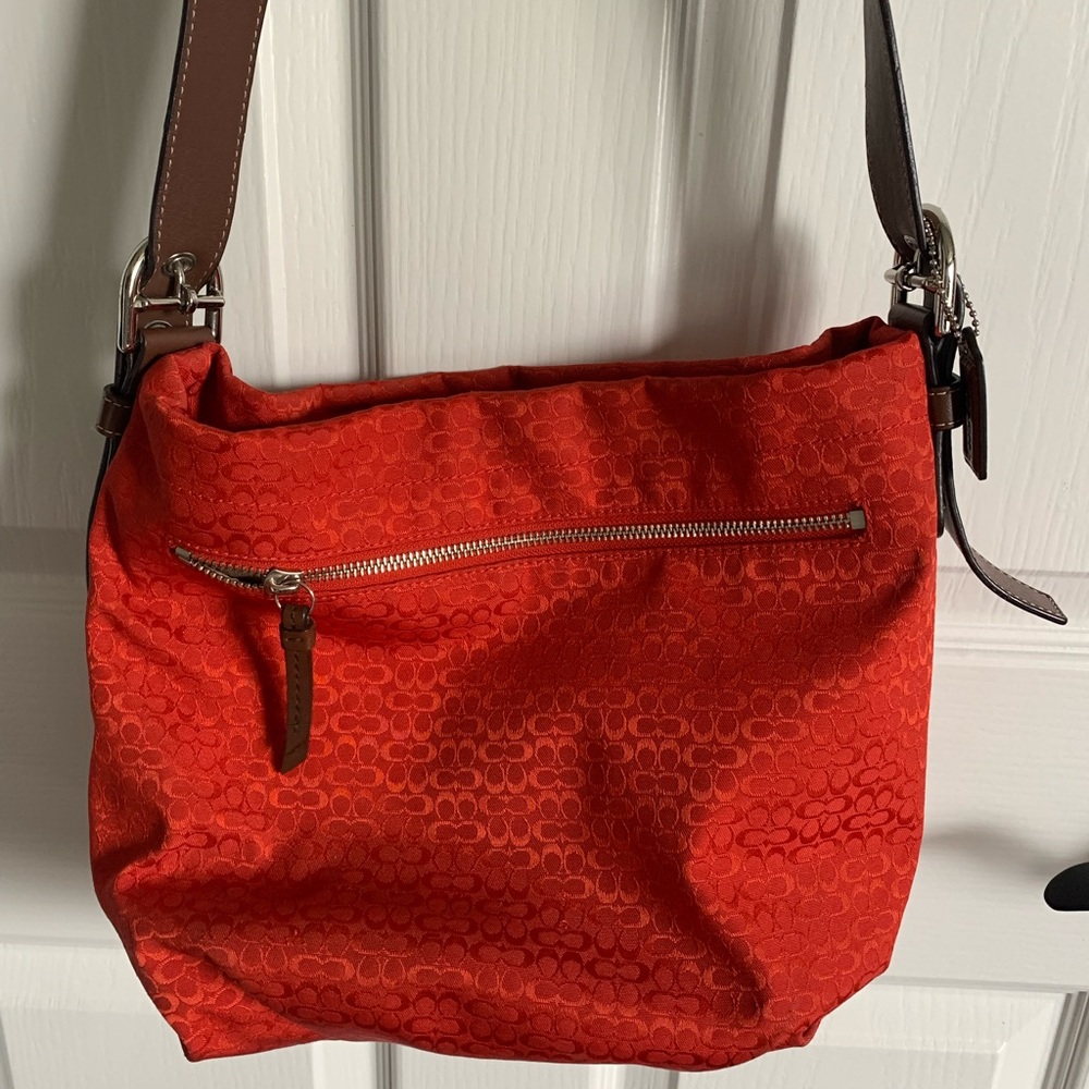 Coach bag with adjustable shoulder strap. Color is beautiful fall orange.